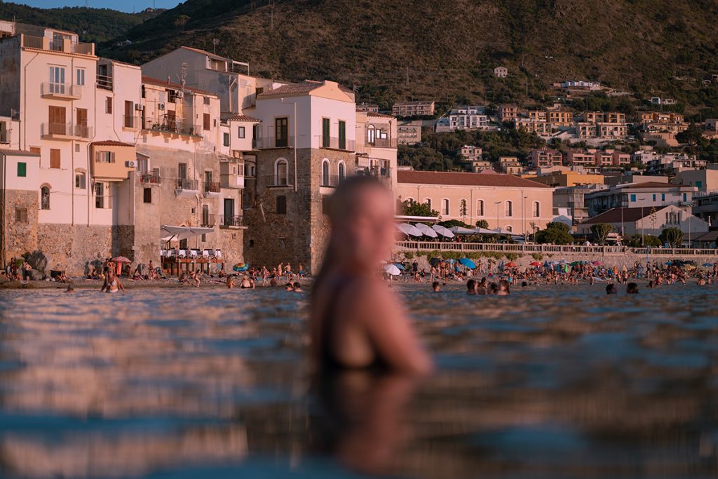 blurred image of a woman in the water by a beach